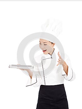 Amazing cook woman chef holding tray and showing something