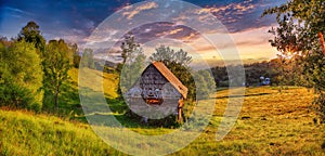 Amazing countryside landscape of romanian village Rogojel with forested hills and grassy meadows in mountains