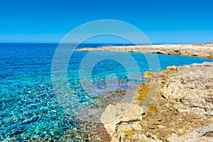 Amazing crystal clear water in the beach of Porto Selvaggio Natural Reserve in Salento, Apulia Italy photo