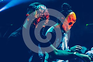 Amazing Djs with mask playing mixing music at Summer Party Festival.