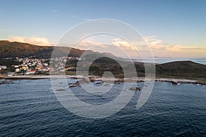 Amazing drone aerial landscape view of mountains in atlantic ocean with waves at sunset in Caldebarcos in Galiza, Spain photo