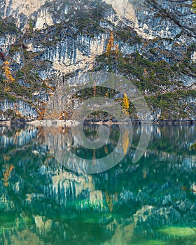 Amazing emerald waters of Lago di Braies in Italy with beautiful reflection photo