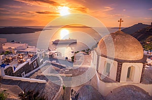 Amazing evening view of Fira, caldera, volcano of Santorini, Greece with cruise ships at sunset.