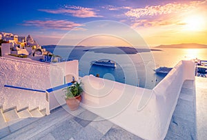 Amazing evening view of Fira, caldera, volcano of Santorini, Greece with cruise ships at sunset.