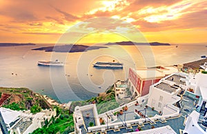 Amazing evening view of Fira, caldera, volcano of Santorini, Greece with cruise ships at sunset. Cloudy dramatic sky