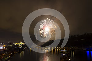 Amazing exploding yellow firework celebration of the new year 2015 in Prague with the historic city in the background