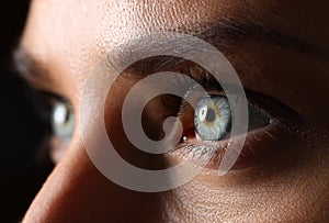 Amazing female green colored eyes in low light technique