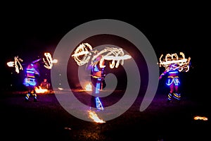 Amazing fire show dance. Fire dancers in beautiful costumes playing with colorful flames