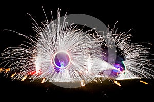 Amazing fire show dance. Fire dancers in beautiful costumes playing with colorful flames