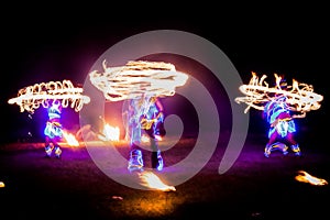 Amazing fire show dance. Fire dancers in beautiful costumes playing with colorful flames