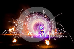 Amazing fire show dance. Fire dancers in beautiful costumes playing with colorful flames