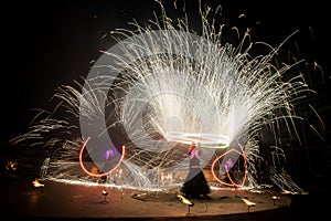 Amazing fire show dance. Fire dancers in beautiful costumes playing with colorful flames