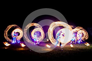 Amazing fire show dance. Fire dancers in beautiful costumes playing with flame