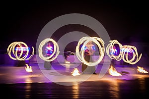 Amazing fire show dance. Fire dancers in beautiful costumes playing with flame