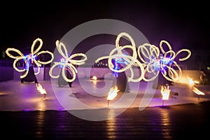 Amazing fire show dance. Fire dancers in beautiful costumes playing with flame