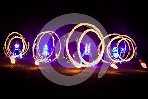 Amazing fire show dance. Fire dancers in beautiful costumes playing with flame