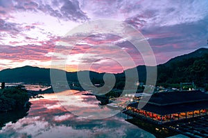 Amazing flaming red fire clouds over fishing port