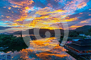 Amazing flaming red fire clouds over fishing port