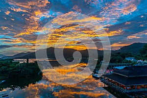 Amazing flaming red fire clouds over fishing port