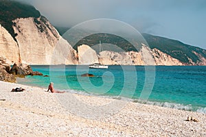 Amazing Fteri beach. A man watching far away in the turquoise sea photo