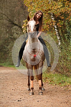 Amazing girl riding a horse without bridle