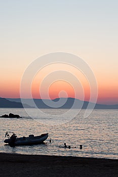 Amazing golden sunset with boat at the city of Chania in Crete, Greece. Aegean Sea