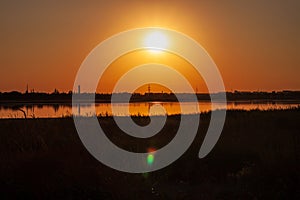 Amazing golden sunset on an empty beach. Orange and red shades on the sky. Wallpaper for desktop, sea travel poster