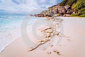 Amazing Granite rocks, white sand and blue clear ocean at Grand Anse, La Digue island, Seychelles. Nature background photo