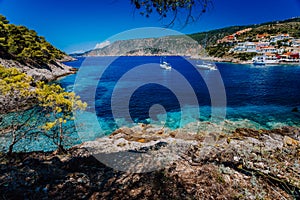 Amazing Greece, white sail boats in blue bay of picturesque colorful village Assos in Kefalonia