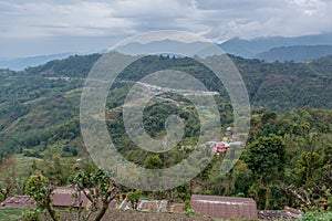 Amazing green wide valley view landscape among mountains covered with trees under cloudy sky