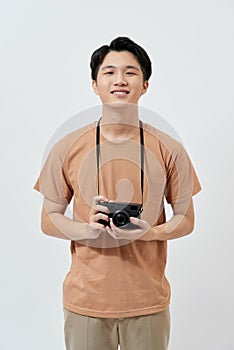 Amazing guy with photo digicam in hands wear casual t-shirt isolated on white background