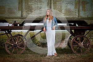 Amazing, hippie girl near trailer in field