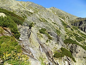 Amazing huge rocky mountains with plants, grass and moss