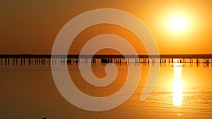 Amazing incredible red sunset with a huge round sun on a salt lake