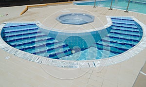 Amazing, inviting gorgeous closeup view of outdoor spa with Jacuzzi and small curved water pool with steps