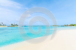 Amazing island in the Maldives ,Beautiful turquoise waters and white sandy beach with blue sky background