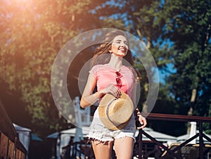 Amazing joyful pretty girl with long brunette hair. having fun on the beach, dancing and smiling, vacation mood.Nice laughing girl