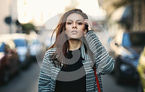 Amazing joyful pretty girl with long brunette hair. posing outdoor. Close up fashion street stile portrait