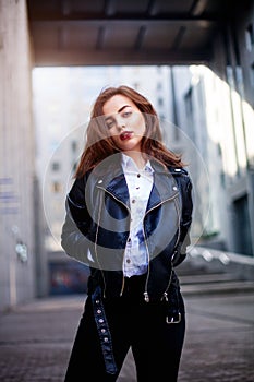 Amazing joyful pretty girl with long brunette hair. posing outdoor. leather jacket,brunette hair, bright red lips