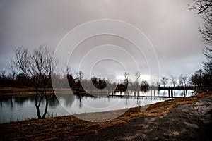 Amazing landscape of bridge reflect on surface water of lake, fog evaporate from pond make romantic scene or Beautiful bridge on l