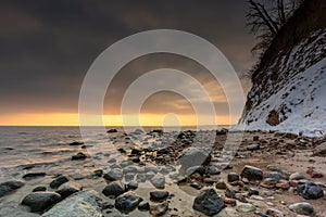 Amazing landscape of frozen rocks on the beach in Gdynia Orlowo at sunrise. Poland