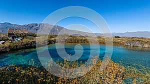 Amazing landscape with a lake and river in the middle of the desert with shades in the water of blue and turquoise green