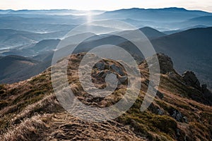 Amazing landscape of mountains layers range at hazy morning. A view of the misty slopes of the mountains in the distance and fores