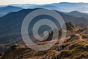 Amazing landscape of mountains layers range at hazy morning. A view of the misty slopes of the mountains in the distance and fores