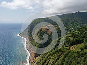 Amazing landscape on the northeast coast of the island of Sao Miguel in the Azores. Panoramic view of the cliff with a path to the