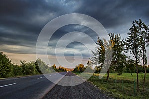 Amazing landscape of road among stone autumn mountains with bright blue soft cloudy blue sky or mountains stretching into the brig