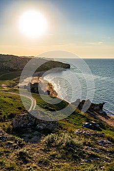 Amazing landscape with sea bay, sand beach and coastal hills and rocks on summer evening at sunset. Trip to seaside. General`s