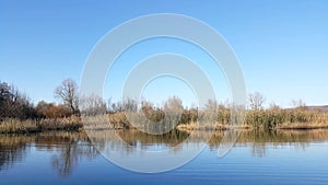 Amazing landscape seen from the kayak. forest reflecting in the lake water. extreme sports combined with relaxation during the aut