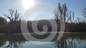 Amazing landscape seen from the kayak. forest reflecting in the lake water. extreme sports combined with relaxation during the aut