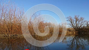 Amazing landscape seen from the kayak. forest reflecting in the lake water. extreme sports combined with relaxation during the aut